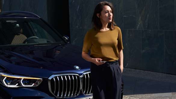 Femme devant BMW Gestion des pannes et des accidents, femme devant BMW