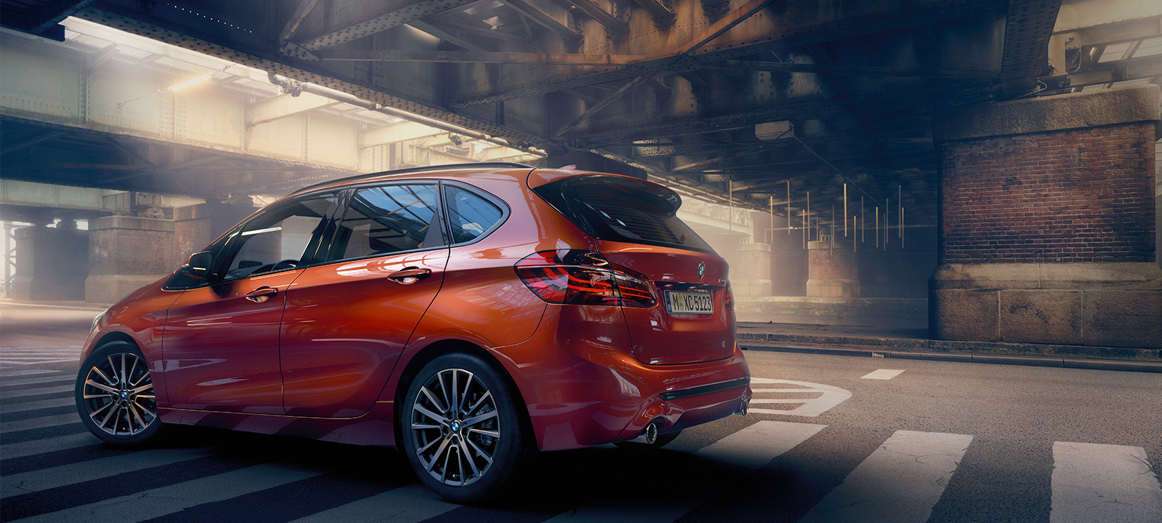 Vue de profil de la BMW Série 2 Active Tourer BMW Série 2 Active Tourer F45 restylage 2018 Sunset Orange metallic, vue de profil dans un hall