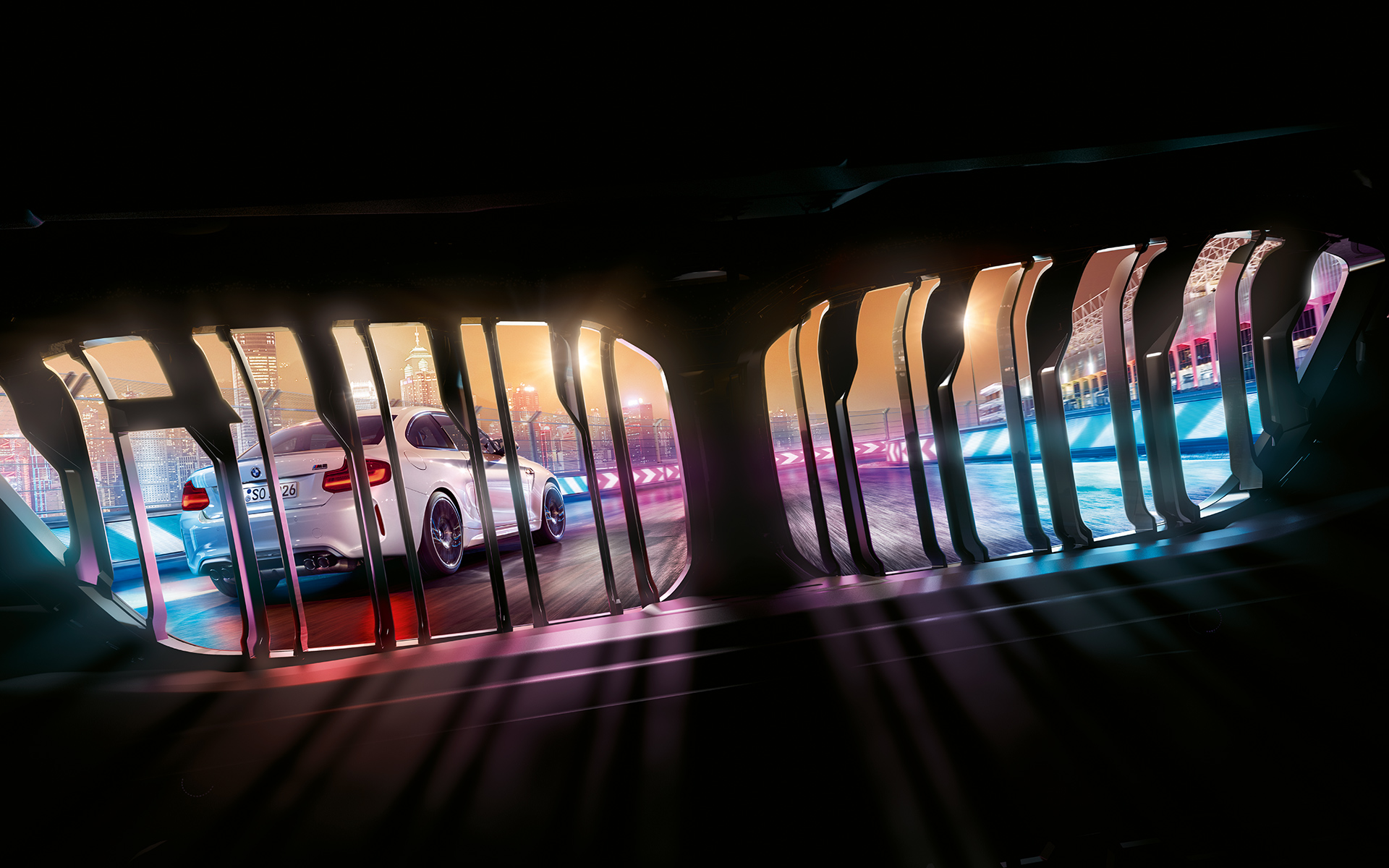 Naseaux BMW M2 Competition Vue à travers les naseaux BMW d'une BMW M2 Competition, de nuit sur un circuit de course.